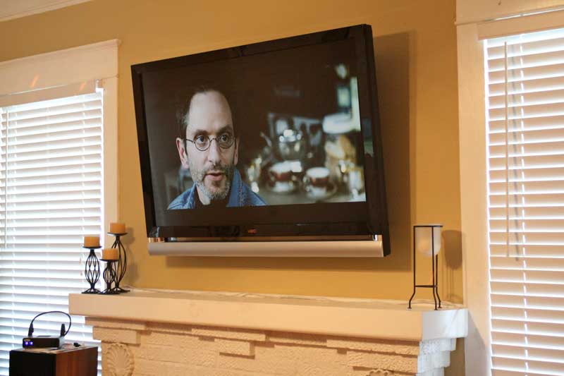 TV wall mount installation with wire concealment over fireplace